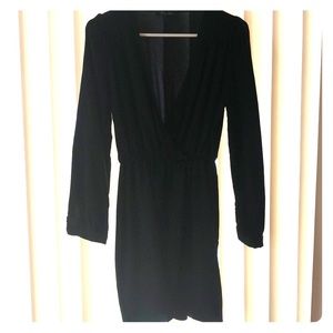 Short black long sleeve dress, low in the front.